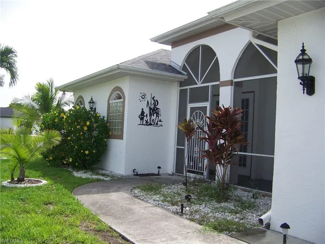 Property entrance with nice tiles sitting area (porch -like) and a French door entry.