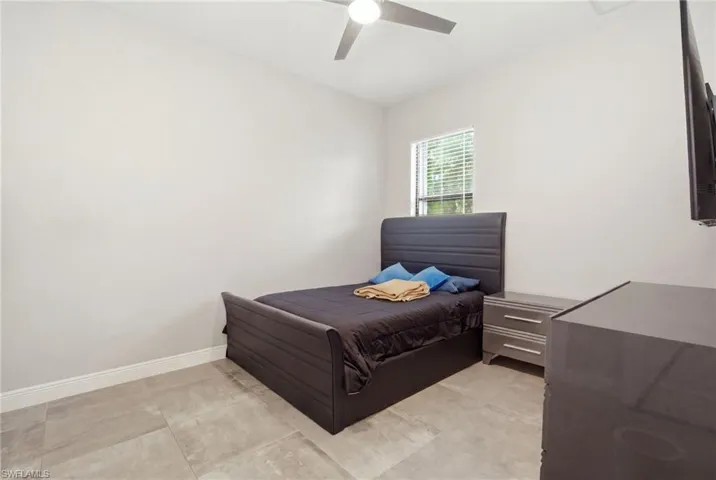 Recessed ceiling fan, window with blinds, and durable tile flooring