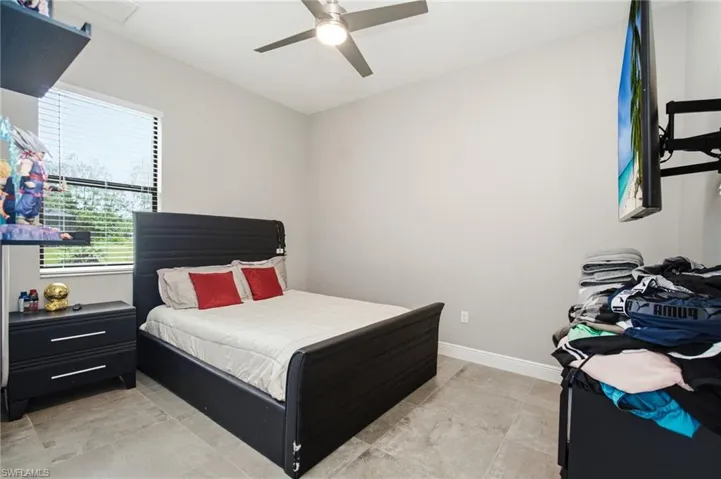 Recessed lighting, ceiling fan, window with blinds, and tile flooring