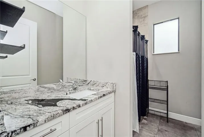 Dual vanity with a stone countertop and two integrated sinks
