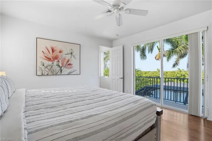 Bedroom featuring light wood-style flooring, a ceiling fan, and access to outside