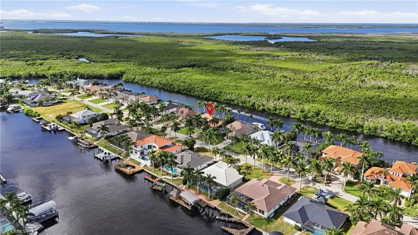 Aerial view of residential area featuring a large body of water