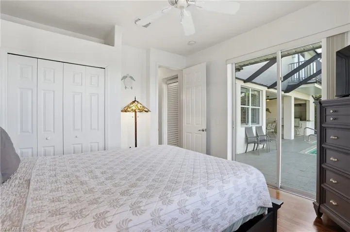 Bedroom with light wood finished floors, a closet, and a ceiling fan