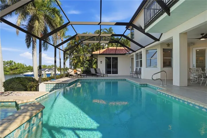 Swimming pool with a patio area, glass enclosure, a sunroom, and ceiling fan
