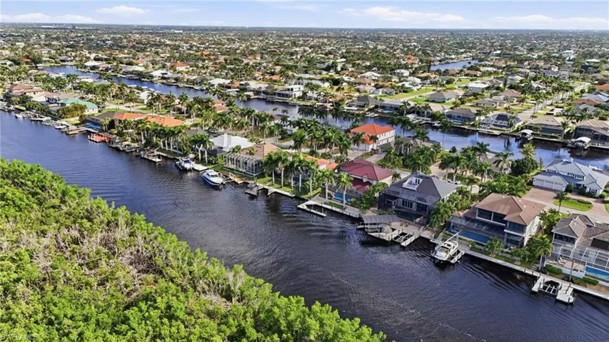 Aerial view of residential area featuring a large body of water