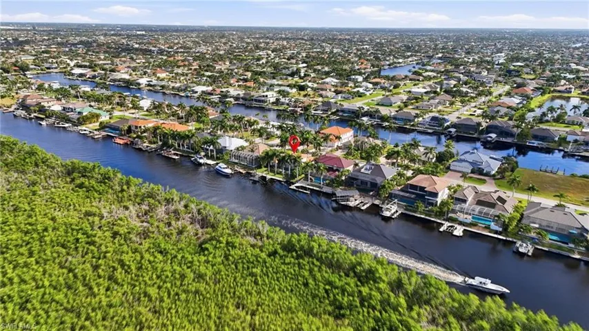 Aerial perspective of suburban area featuring a nearby body of water