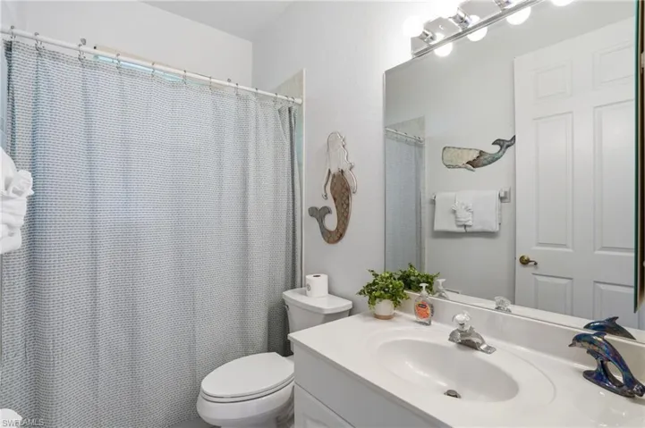 Full bath with vanity and curtained shower
