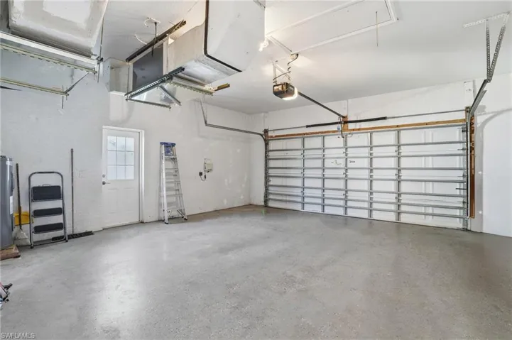Garage with electric water heater and a garage door opener