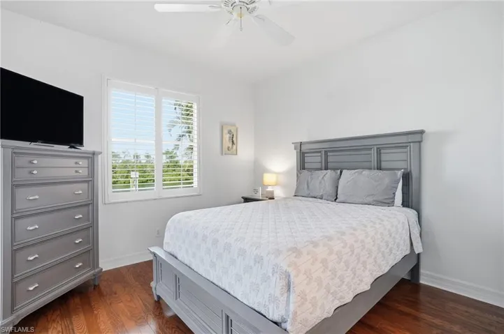 Bedroom featuring dark wood-style floors and a ceiling fan