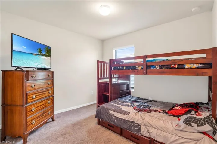 Carpeted bedroom with baseboards