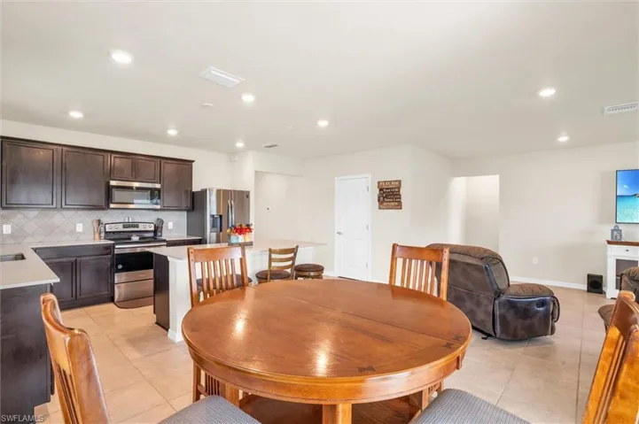 Dining room featuring recessed lighting and light tile patterned flooring
