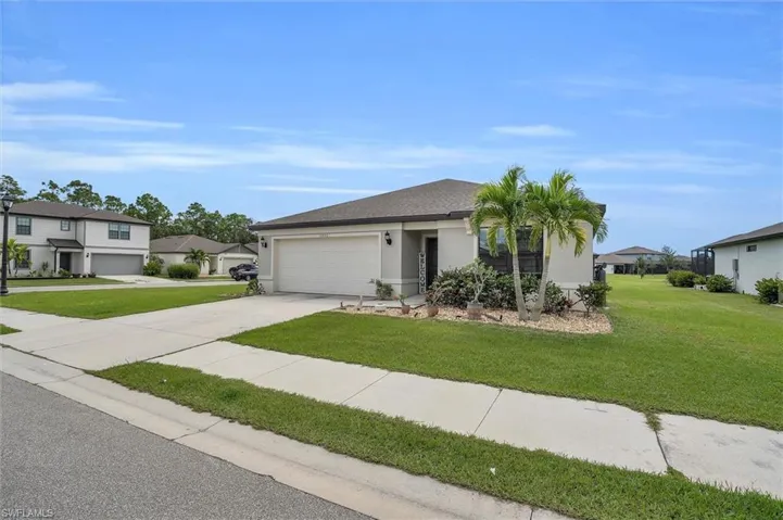 Single story home featuring driveway, an attached garage, a front yard, stucco siding, and a residential view