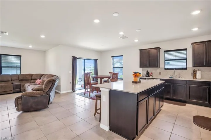 Kitchen featuring tasteful backsplash, recessed lighting, light countertops, open floor plan, and light tile patterned floors