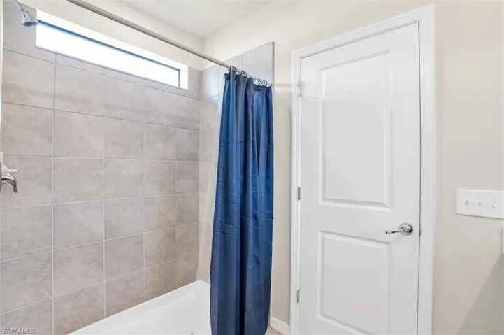Full bath featuring a shower with shower curtain