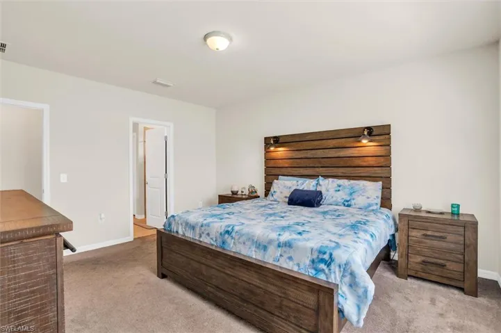 Bedroom featuring carpet flooring and baseboards