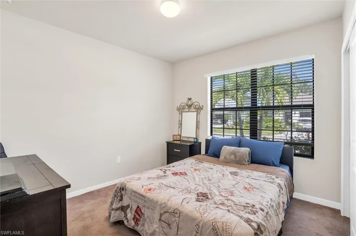 Bedroom with carpet flooring and baseboards