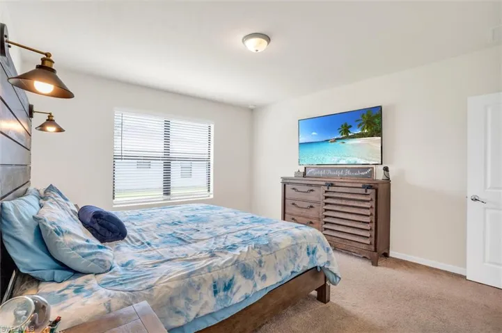 Carpeted bedroom featuring baseboards
