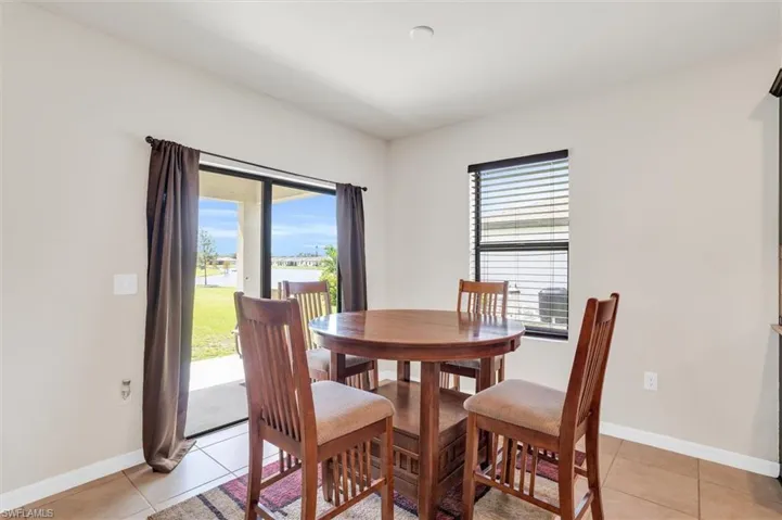 Dining area with light tile patterned floors