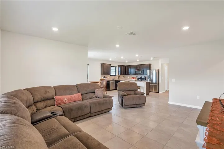 Living area with recessed lighting and light tile patterned floors