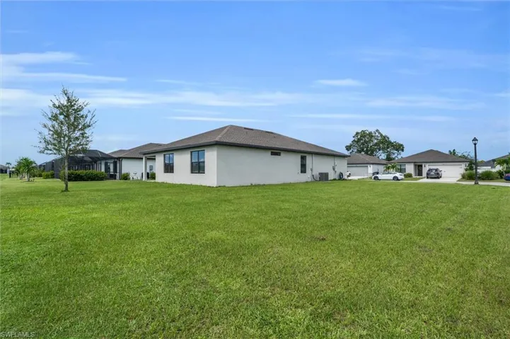 View of property exterior featuring a yard and stucco siding