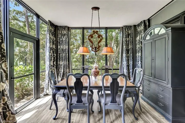 Dining space with light wood finished floors and expansive windows