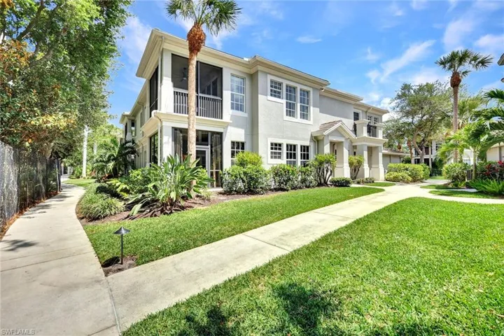 View of front of property with stucco siding and a front lawn
