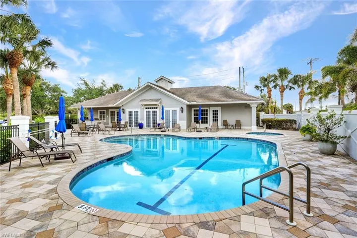 Community pool with a community hot tub, fence, a patio, and french doors