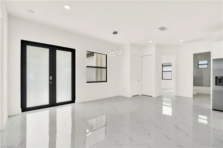 Unfurnished room with french doors and recessed lighting