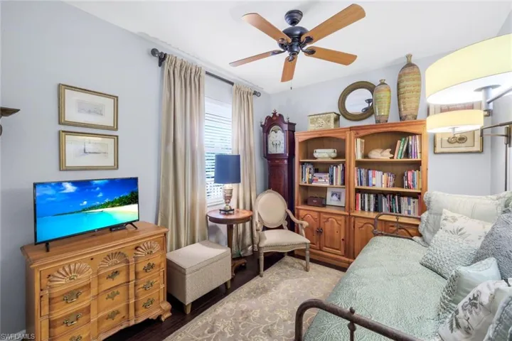 Living area with ceiling fan and wood finished floors