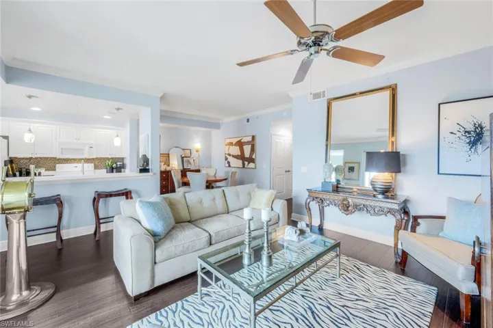 Living area featuring crown molding, dark wood-style flooring, a ceiling fan, and recessed lighting