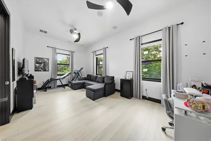 Office area with light wood-style floors and baseboards