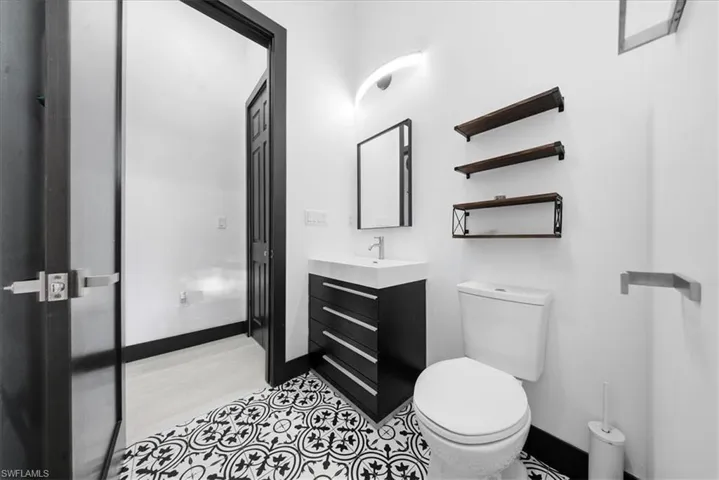 Half bathroom featuring vanity and baseboards