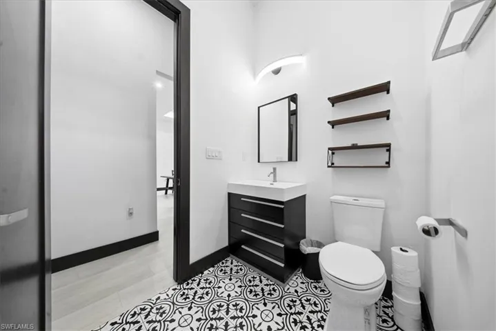 Half bath featuring vanity and toilet