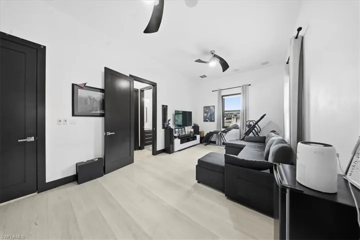 Living area featuring light wood-type flooring and baseboards