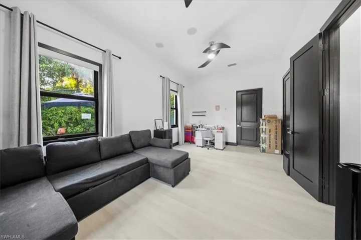 Living area with light wood-style flooring and an office area