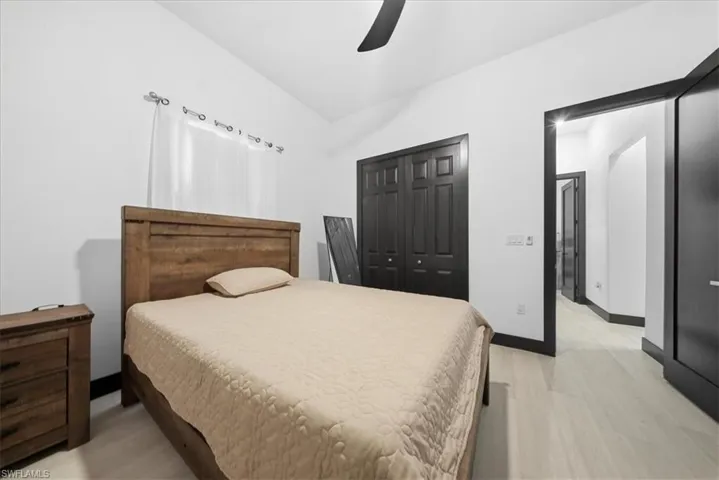 Bedroom featuring a closet, ceiling fan, and light wood finished floors