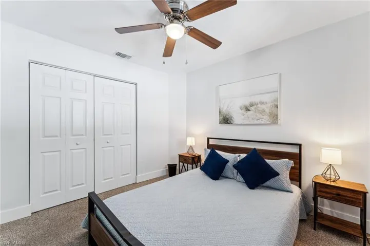 Bedroom with carpet flooring, a closet, baseboards, and ceiling fan