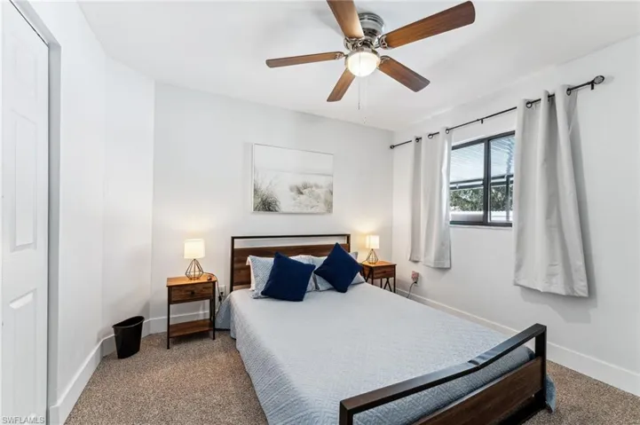 Bedroom featuring carpet, baseboards, and a ceiling fan