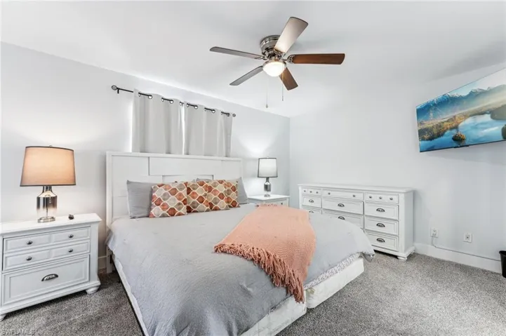 Bedroom featuring carpet flooring, a ceiling fan, and baseboards