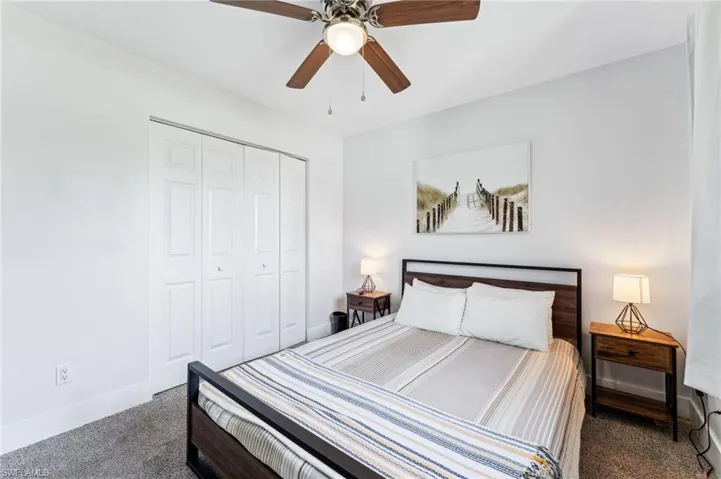 Bedroom with carpet, baseboards, a closet, and a ceiling fan