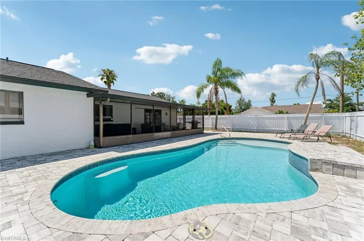 View of pool with a patio area, a fenced backyard, and a sunroom