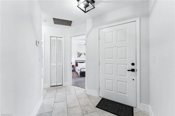 Foyer featuring baseboards and light tile patterned floors