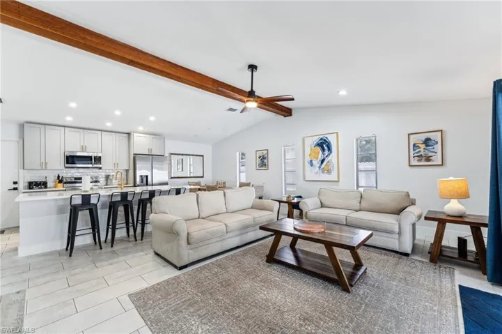 Living room featuring recessed lighting and a ceiling fan