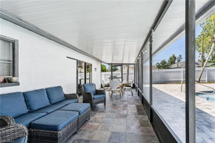 Sunroom featuring an outdoor living space and outdoor dining space