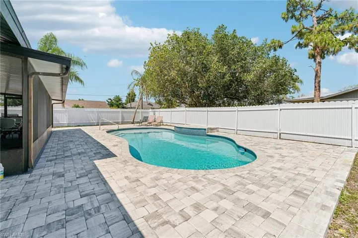 View of pool with a patio area and a fenced backyard