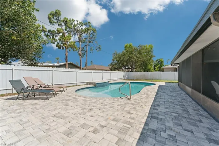 View of swimming pool with a patio area, a fenced backyard, and a sunroom