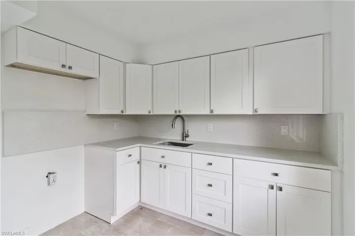 Kitchen with white cabinetry and sink