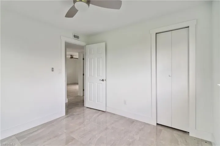 Unfurnished bedroom featuring ceiling fan and a closet