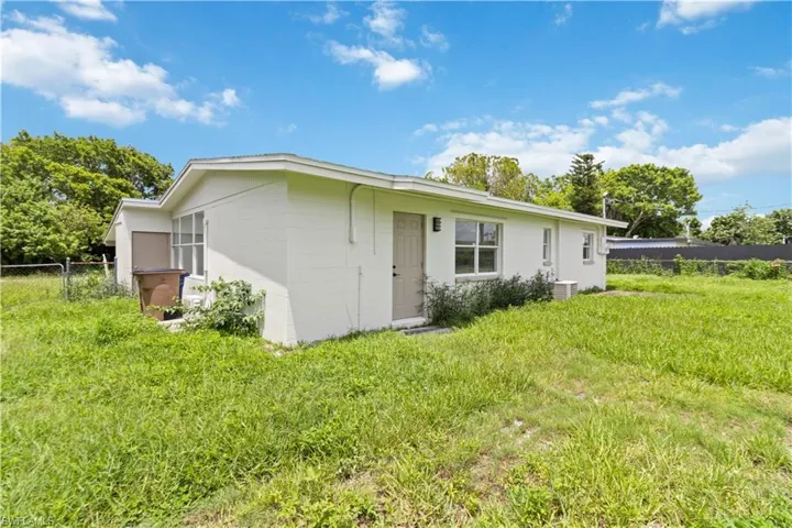 Rear view of property featuring a yard