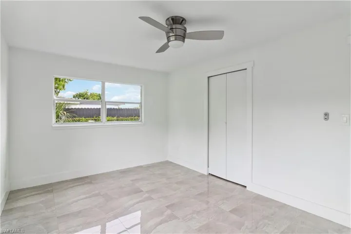 Unfurnished bedroom featuring ceiling fan and a closet